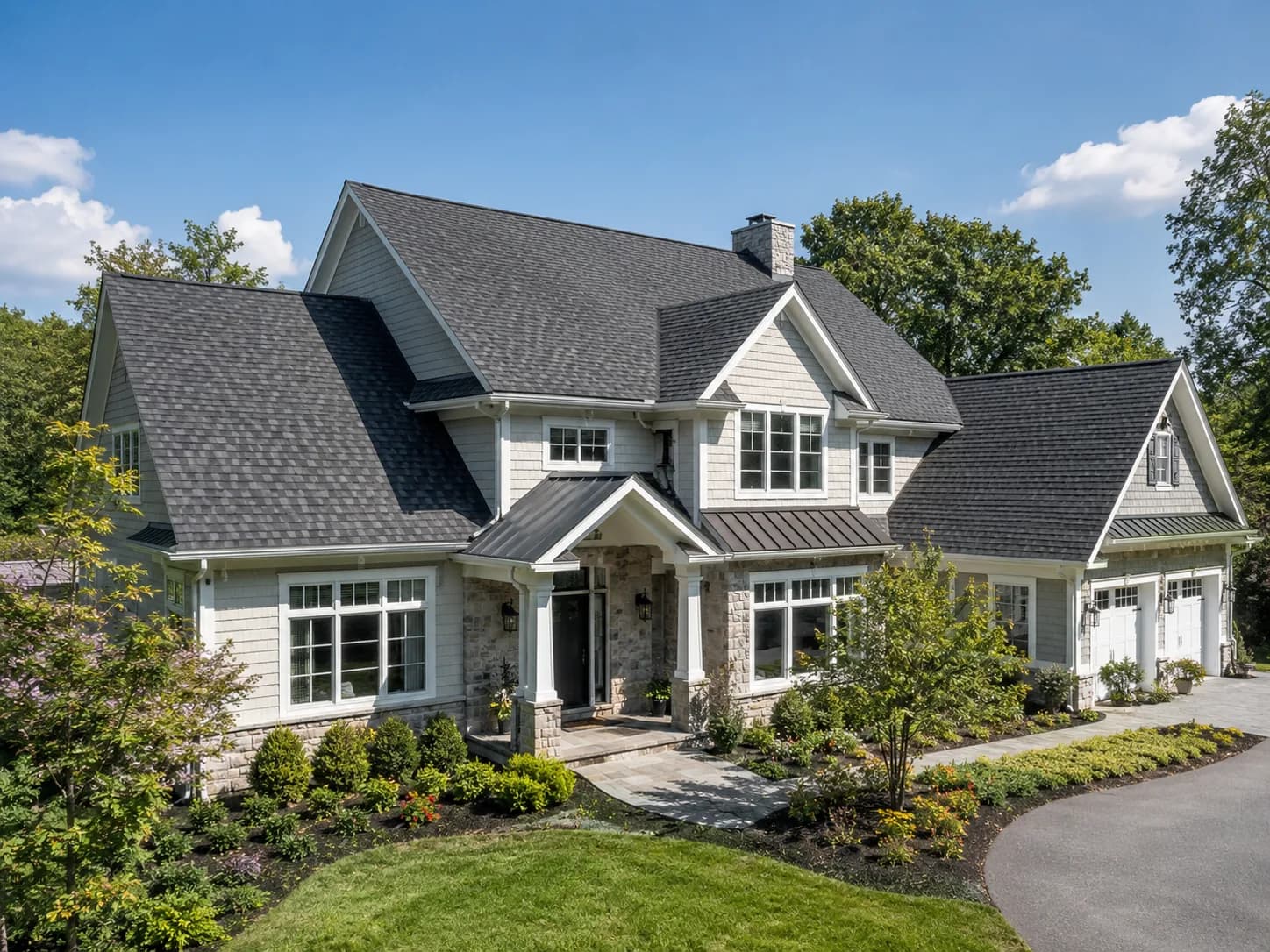 A premium residential home with a clean asphalt shingle roof.